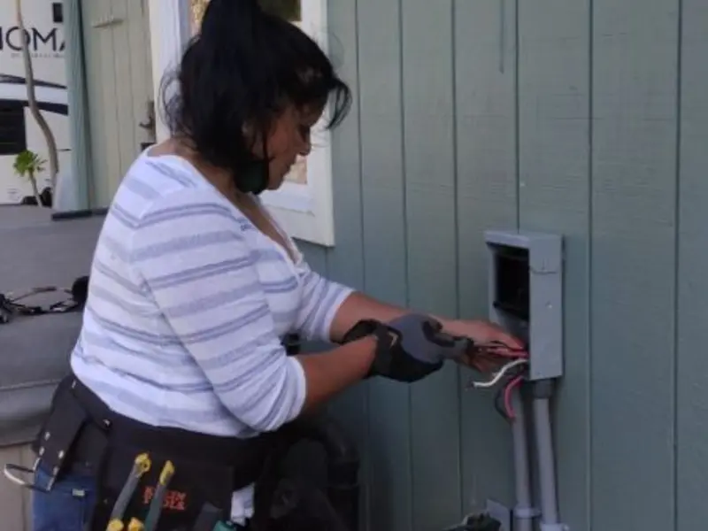 Licensed electrician wiring an exterior subpanel in Webster